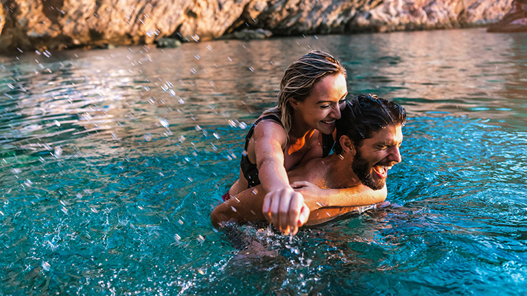 Couple in ocean on vacation in Huatulco 