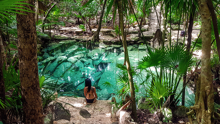 Person relaxing by lagoon in Cancun 