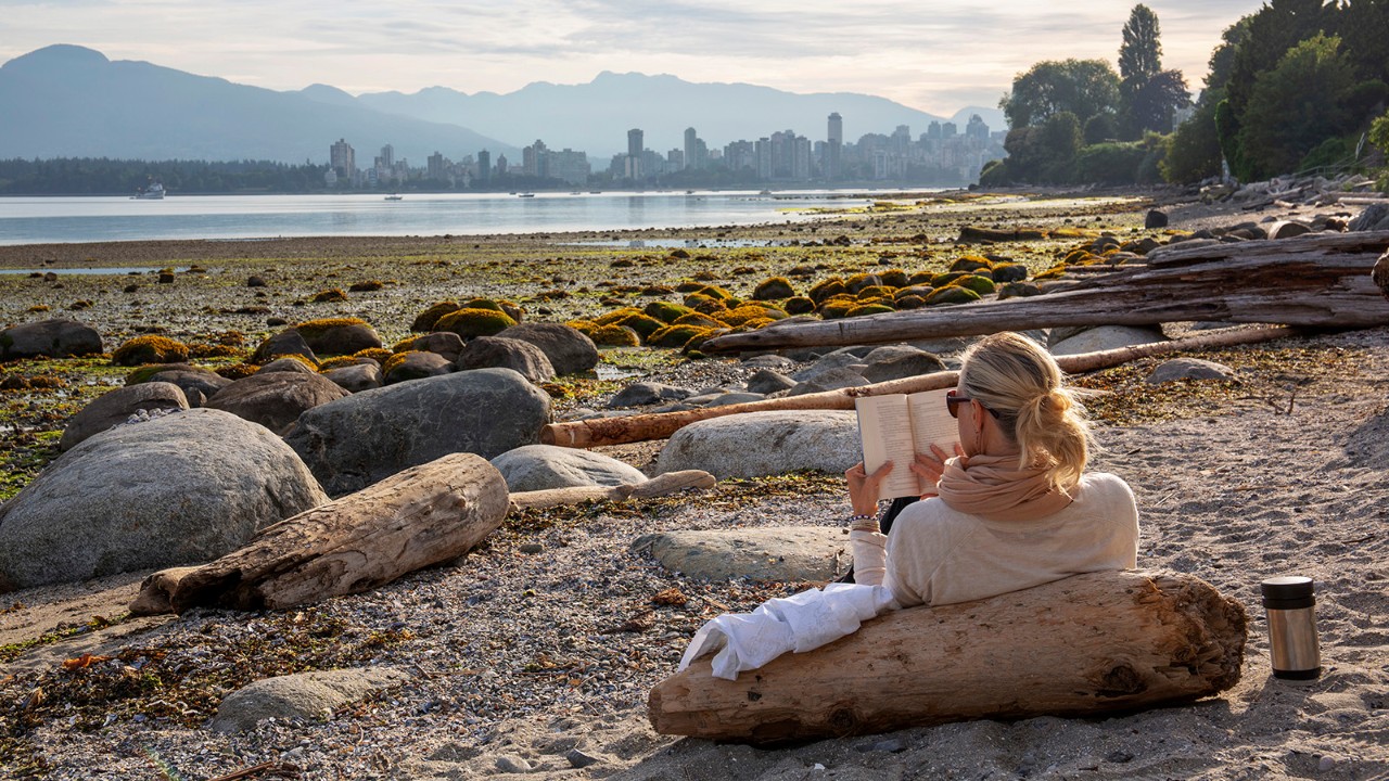 View from beach across bay to city skyline, Vancouver, BC