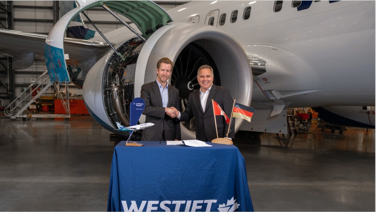 WestJet Chief Executive Officer Alexis von Hoensbroech and Lufthansa Technik Chief Operations Officer Harald Gloy (left and right) sign historic aircraft engine maintenance contract in Calgary.